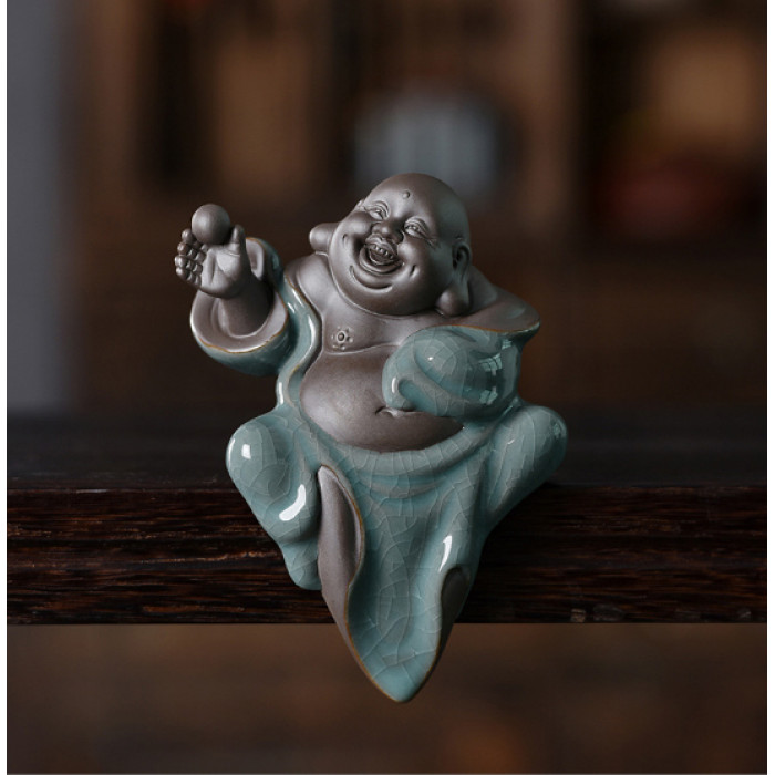 Hotei figurine with a pearl on the edge