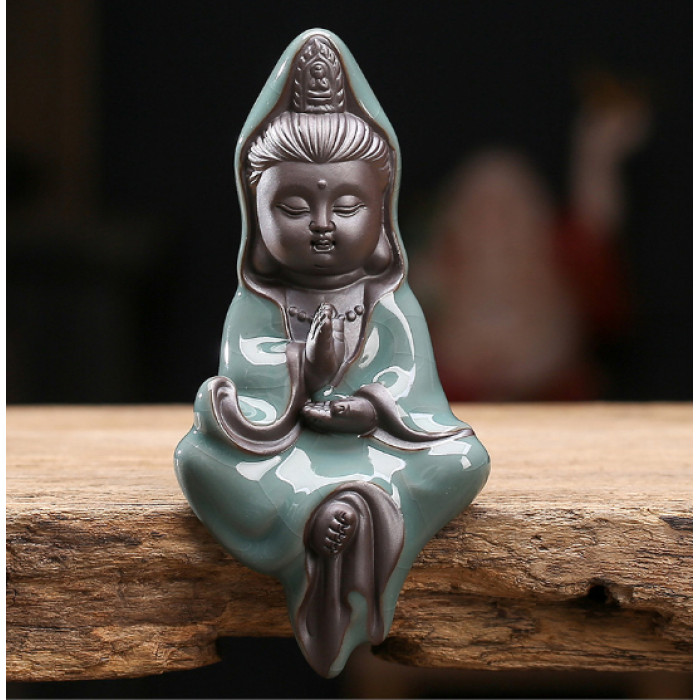 Little Guan Yin statuette on the edge